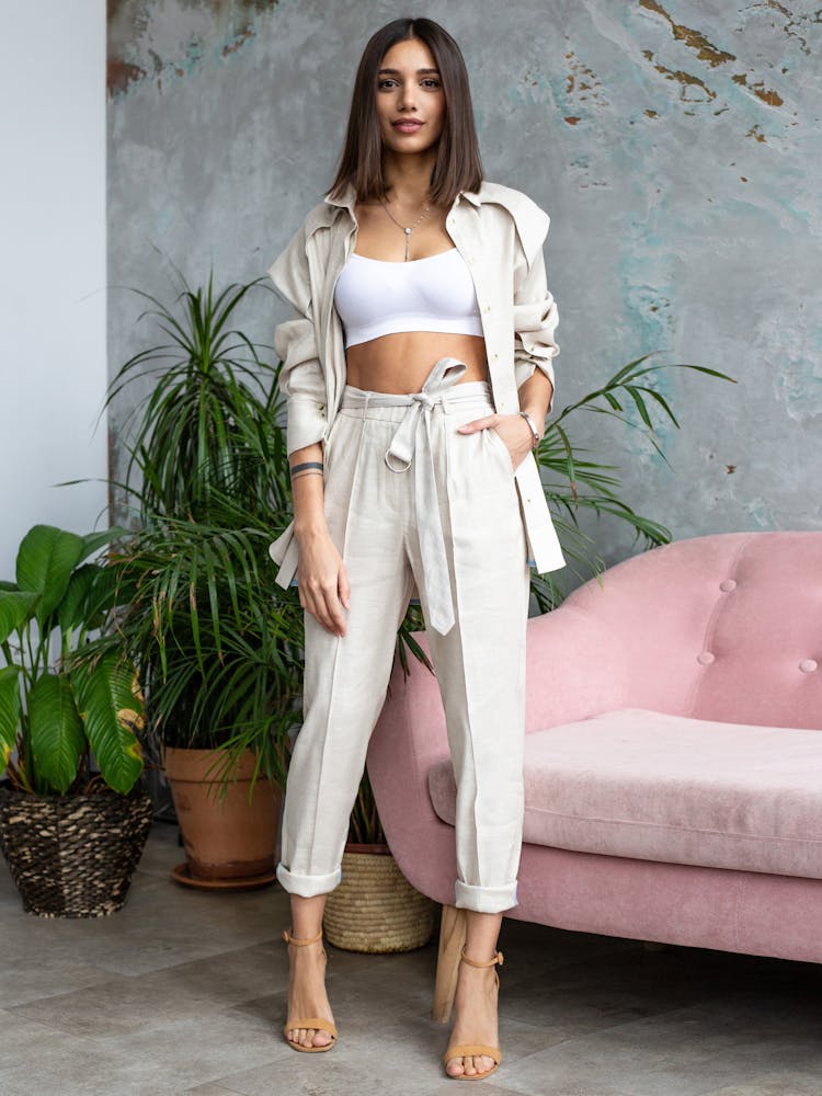 Young Woman Posing In A Fashionable Outfit And High Heels 