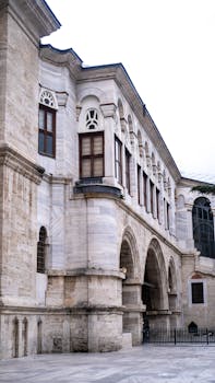 Elegant stone architecture with arched windows and intricate detailing, showcasing historical design.