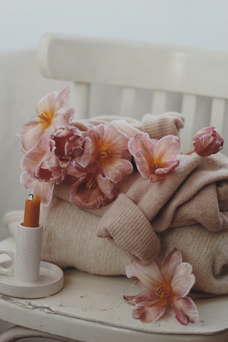 Pile Of Cozy Sweaters On Chair