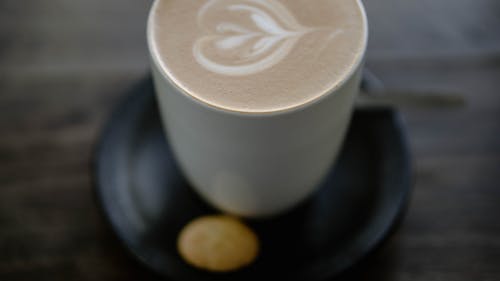 Free A Cup of Coffee and a Small Cookie  Stock Photo