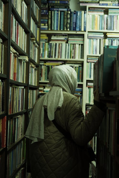 Back View of a Woman Walking in Library 