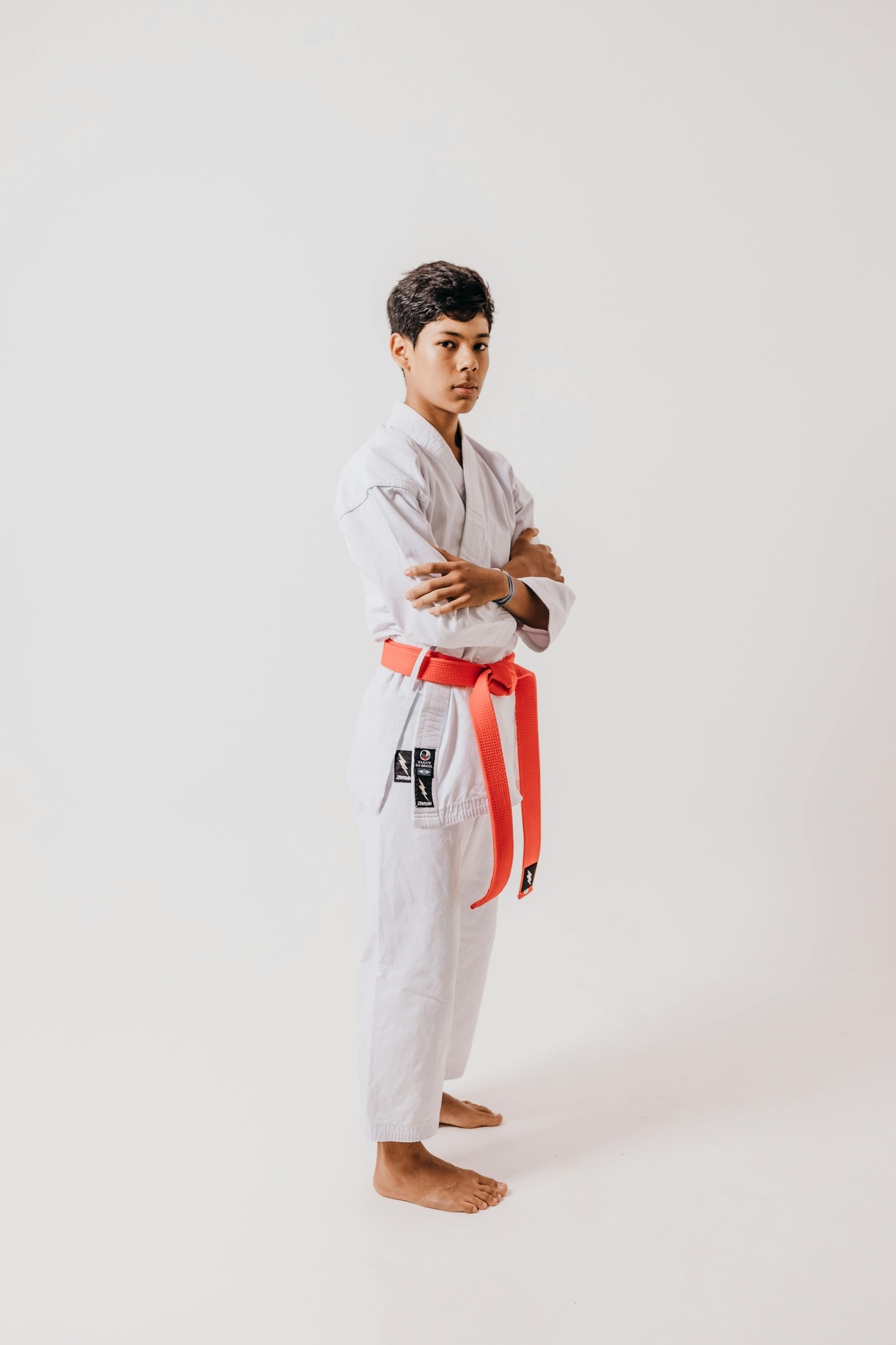 boy in kimono and red belt with folded arms