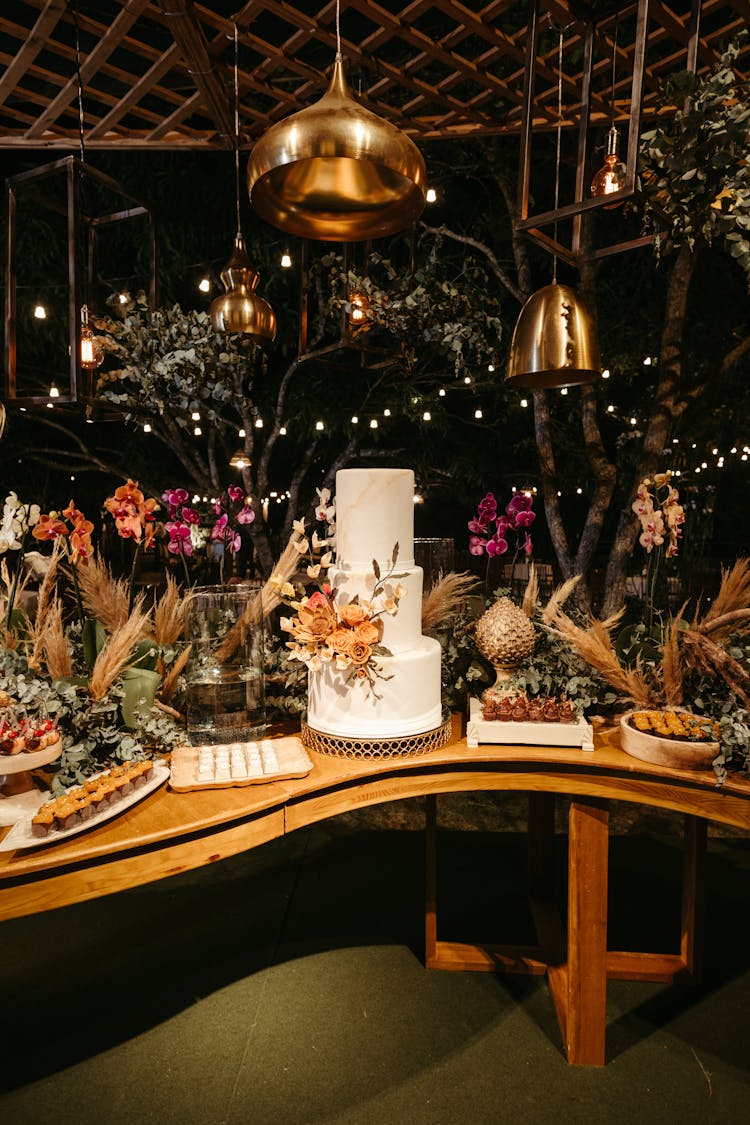 Layer Cake And Flower Decorations On A Table At A Party 