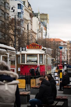 A vibrant street view of Prague featuring a vintage tram and lively urban atmosphere.