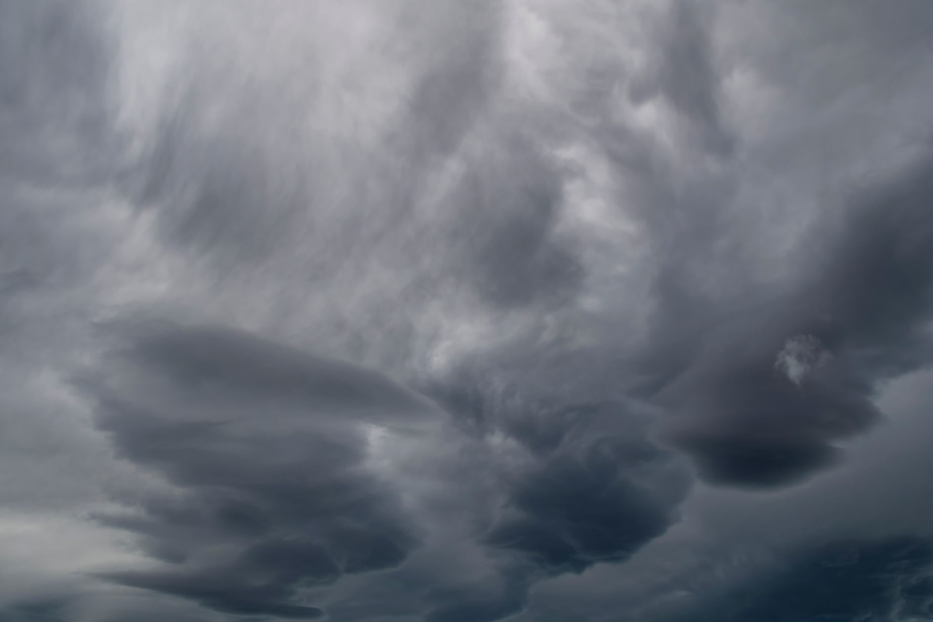 A captivating view of dark, dramatic rain clouds forming in an overcast sky.