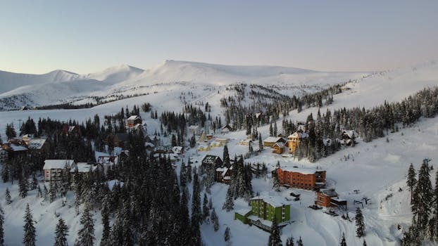 A picturesque winter landscape of a snowy ski resort in the Carpathian Mountains captured from above.