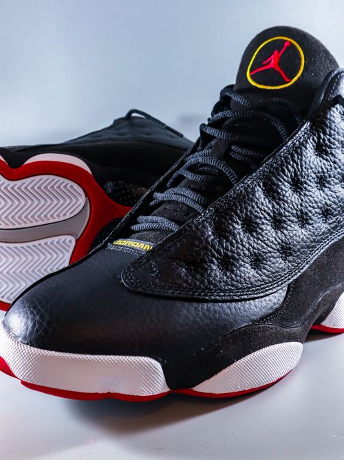 Free Detailed close-up of black Air Jordan 13 sneakers, showcasing design and texture. Stock Photo