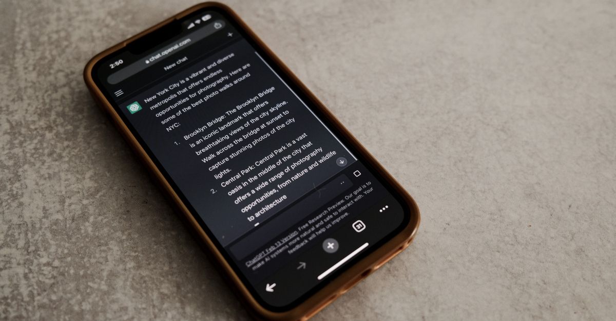 Close-up of smartphone with text about New York City tourist spots. Technology and communication theme.