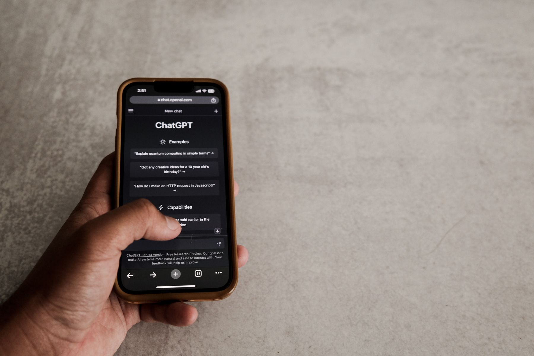 A hand interacting with an AI chatbot conversation on a smartphone