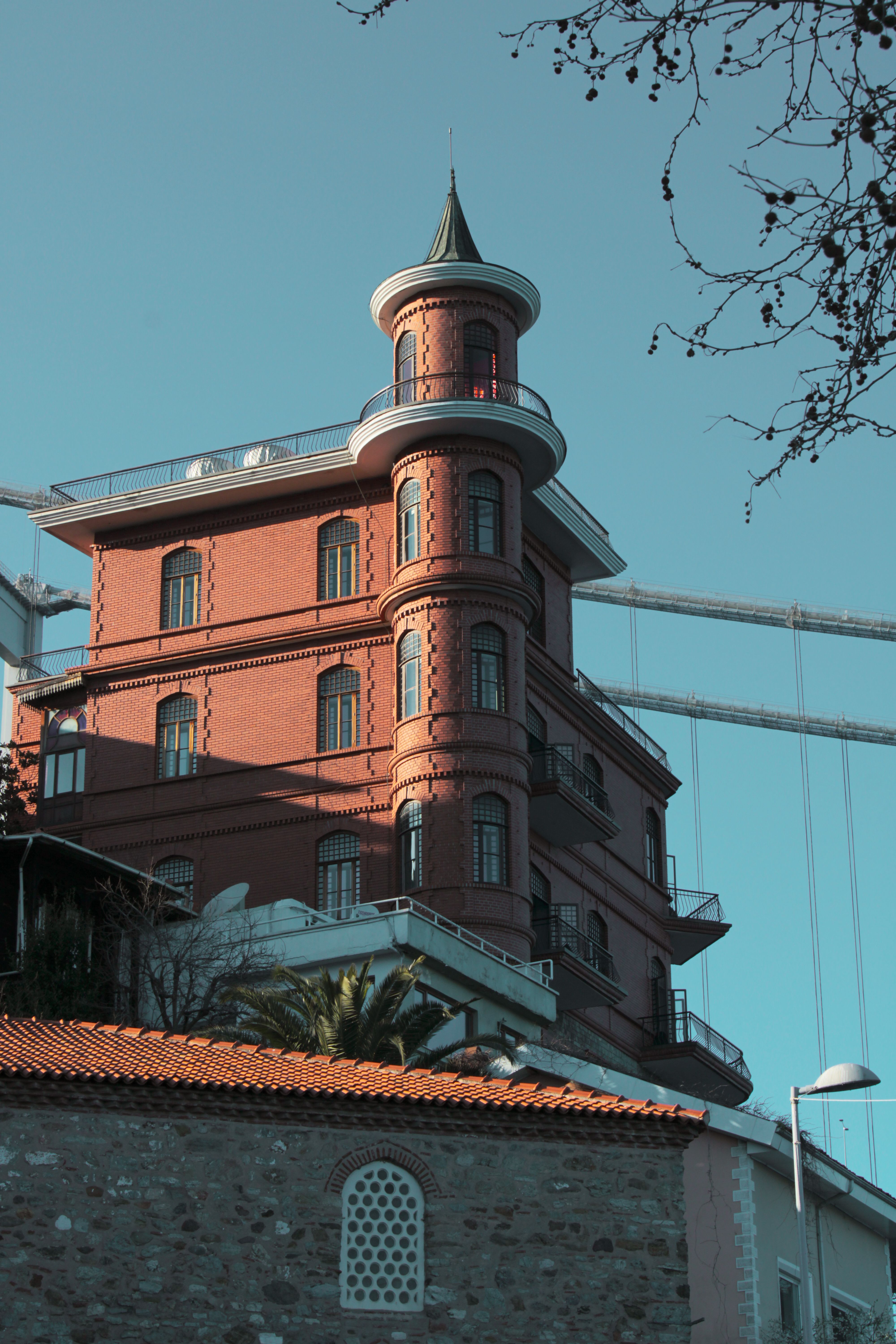 Stunning red brick mansion with unique architecture against a clear blue sky in Istanbul, Turkey.