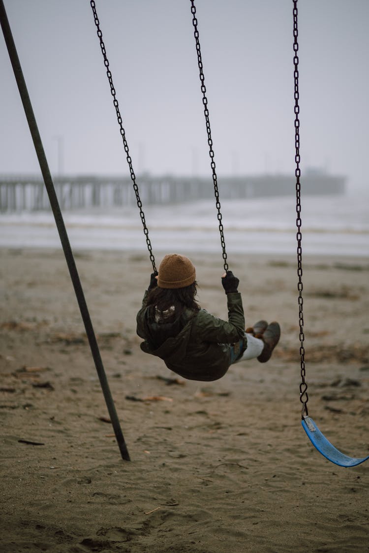 Woman On Swing On Beach