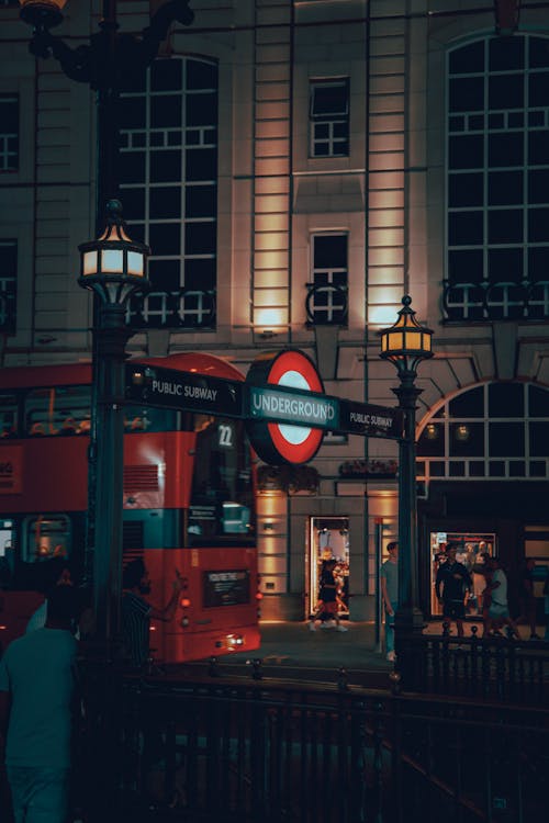 A red double decker bus at night