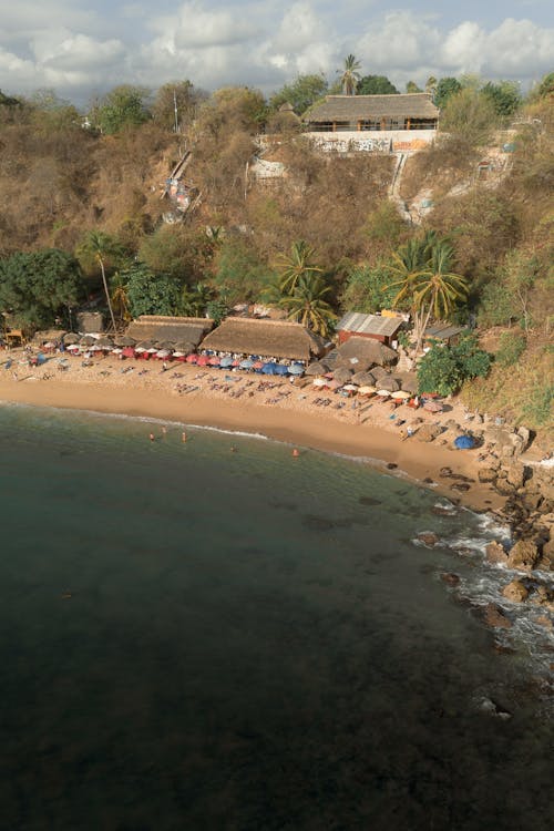 Free A beach with a bar and a few people on it Stock Photo