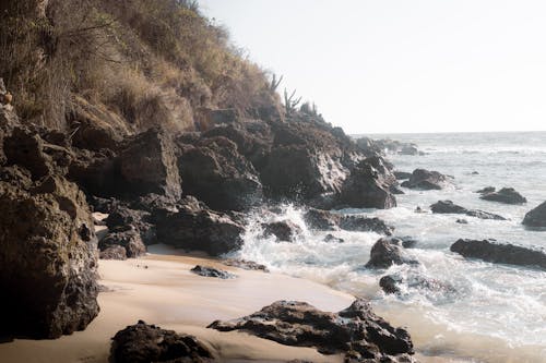 Free A beach with rocks and water in the background Stock Photo