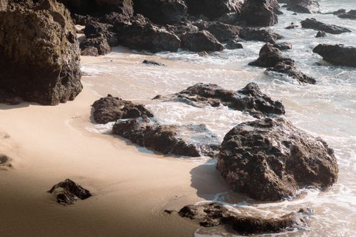 Free Scenic view of rocky shoreline and gentle ocean waves in Puerto Escondido, Mexico. Stock Photo