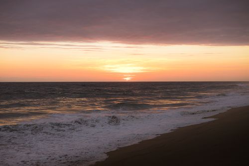 Free Breathtaking sunset view over the ocean at Puerto Escondido, Mexico. A serene and picturesque scene. Stock Photo