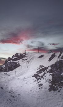 Captivating snowy mountain scene at dusk in Innsbruck, Austria, with dramatic skies.