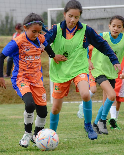 Free Energetic young girls compete in a lively soccer match outdoors. Stock Photo