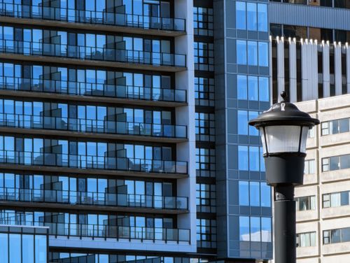 Free Contemporary building facade in Halifax, featuring modern glass balcony designs and a classic street lamp. Stock Photo