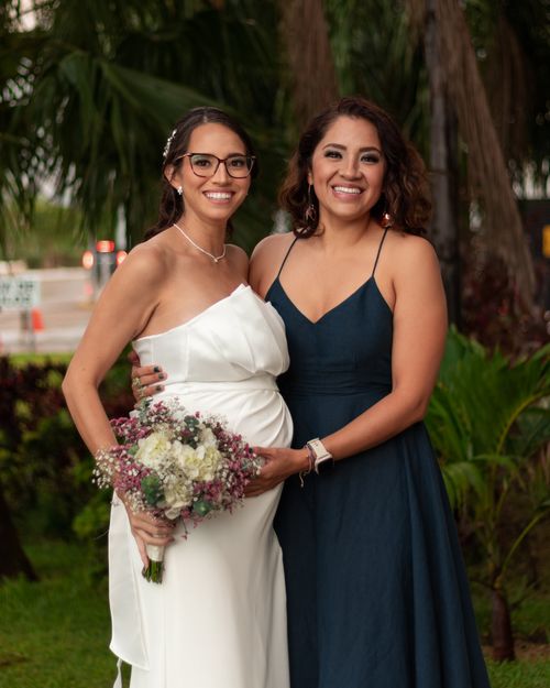 Free A beautiful portrait of two women in elegant dresses at an outdoor wedding in Mérida, México. Stock Photo