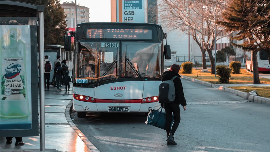 bus leaving person sidewalk