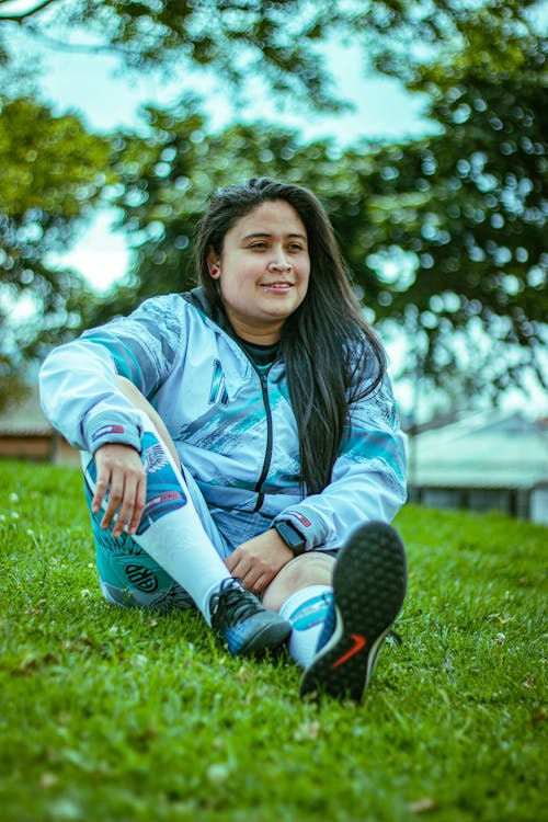 Woman Sitting and Posing in Sports Clothes