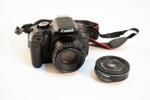Free Detailed shot of a DSLR camera with detachable lens on a white background. Perfect for photography enthusiasts. Stock Photo