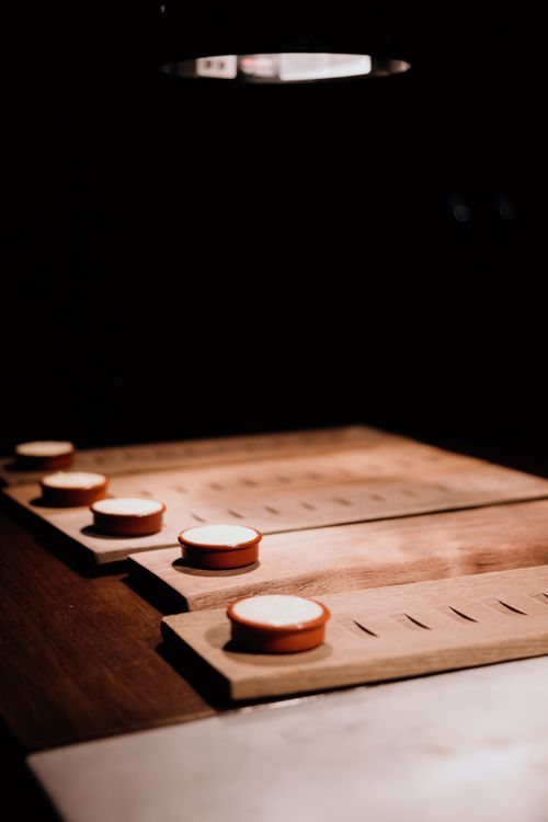 Free Warmly lit wooden boards with candles in a cozy restaurant atmosphere. Stock Photo
