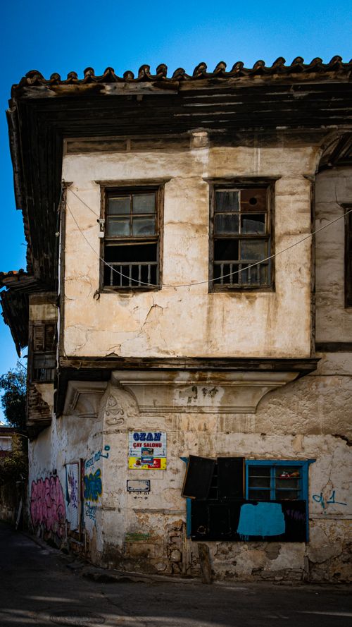 Free Exterior of an old, abandoned building with graffiti and weathered walls, in bright daylight. Stock Photo