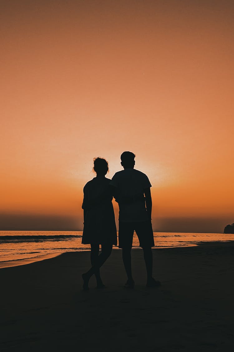 Silhoeutte Of Couple On Beach At Dusk