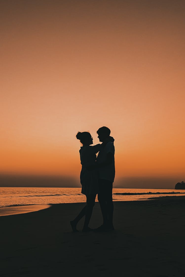 Silhouette Of An Embracing Couple On A Beach 