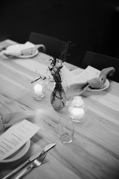 Free A sophisticated black and white dining table setup with candles and a floral centerpiece. Stock Photo