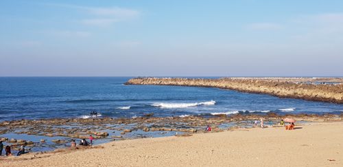Free Idyllic seaside scene with people relaxing on the Rabat shoreline, Morocco. Stock Photo
