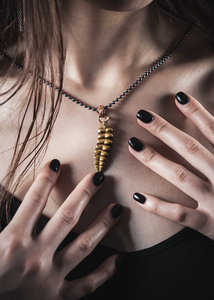 Close Up Of Woman With Golden Dragon Tail Necklace