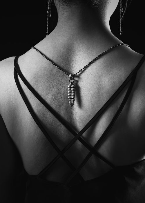 Free Black and white back view of woman wearing a stylish necklace, highlighting fashion elegance. Stock Photo