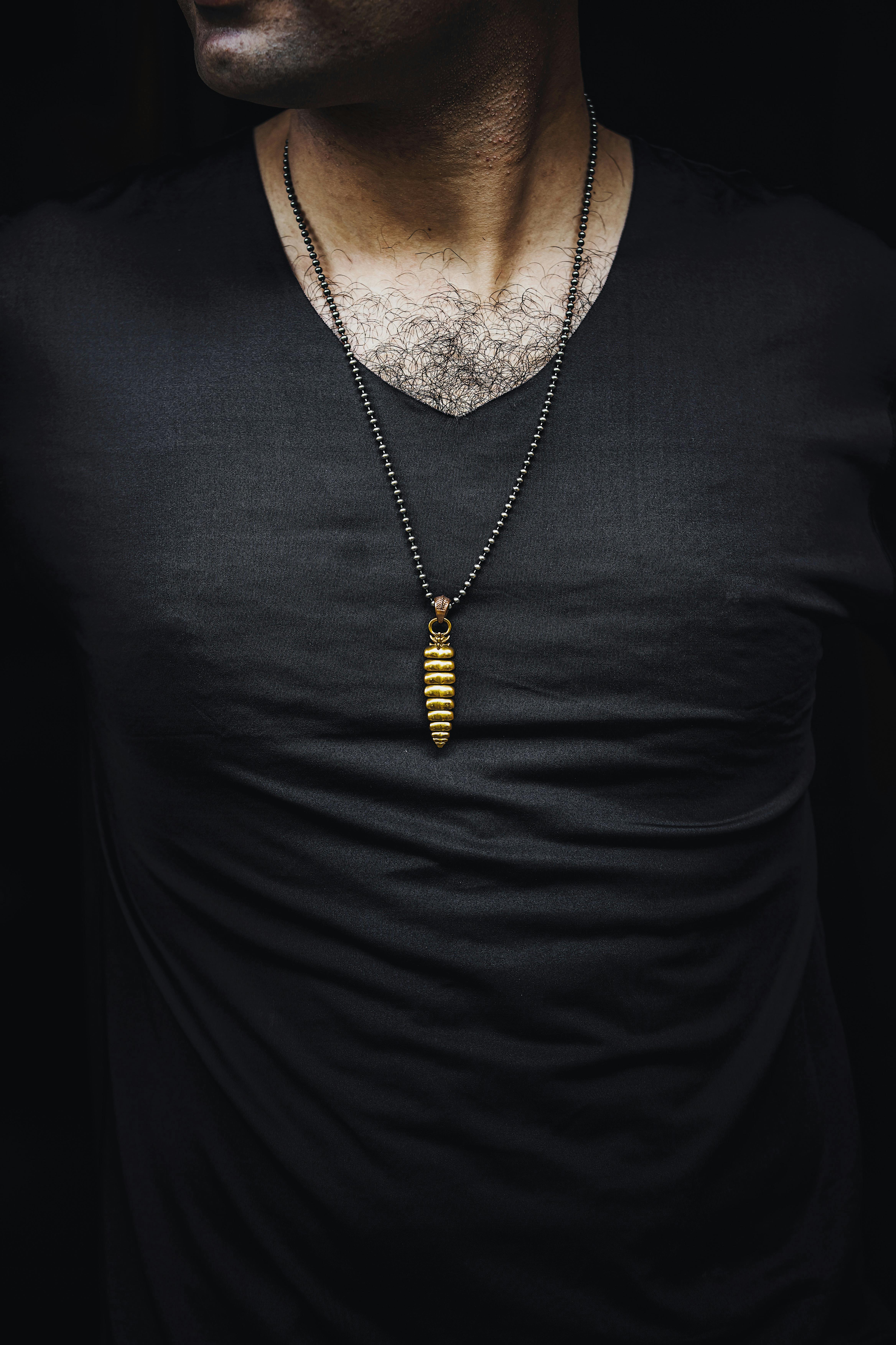 Man Wearing Rattlesnake Tail Pendant Necklace and Wristwatch · Free Stock  Photo