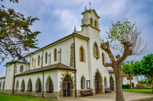 Free Beautiful Gothic-style church in Cadavéu, Asturias, set against a lush landscape. Stock Photo