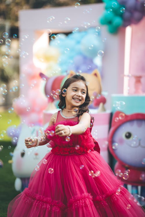 Bubbles over Smiling Girl in Dress