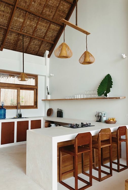 Minimal wood-led kitchen with clean cabinetry, open shelving, warm tones and restrained everyday objects