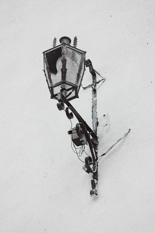 Black and White Photo of a Lantern on a Wall