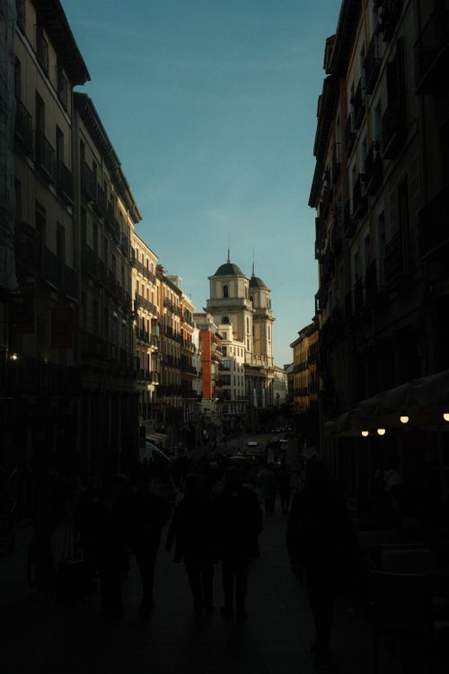 Free Captivating city street view featuring historic architecture under a clear sky at dusk. Stock Photo