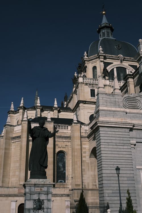 Free Vertical view of Almudena Cathedral's sacral architecture under clear blue sky in Madrid. Stock Photo