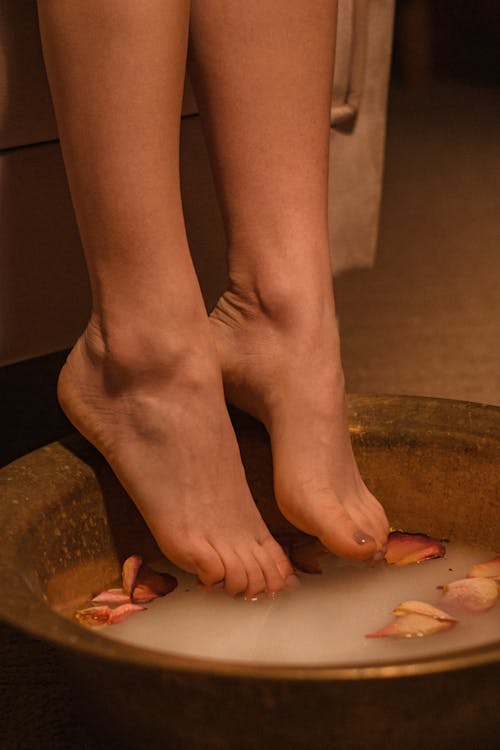 Close-up Photo of Feet in a Bowl