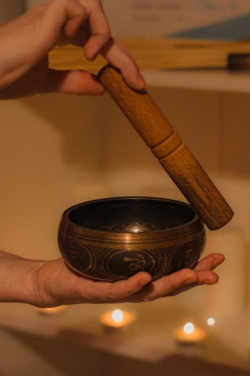 Hands Holding a Tibetan Singing Bowl 