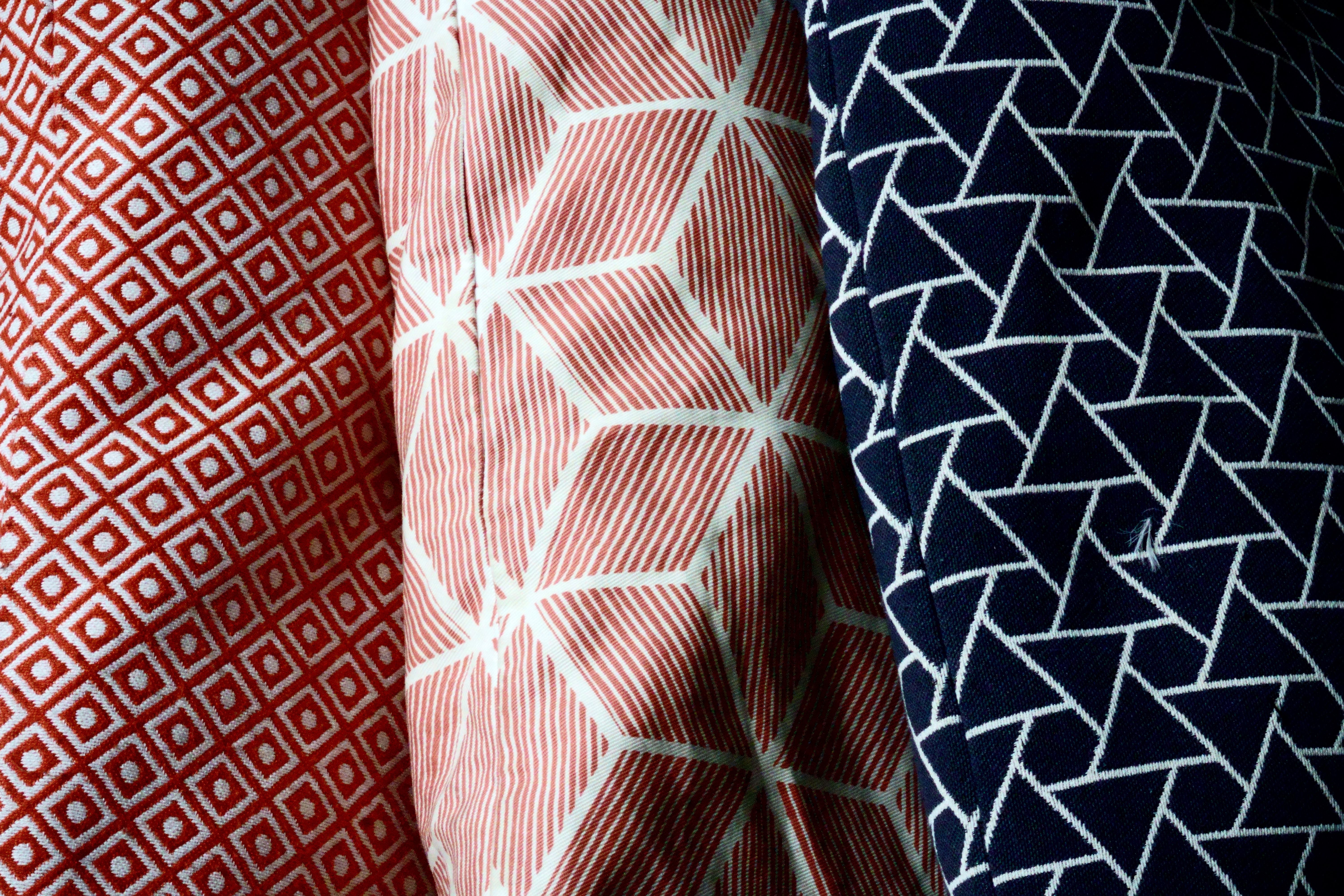 Close-up of vertical red and white stripes on a corrugated metal wall