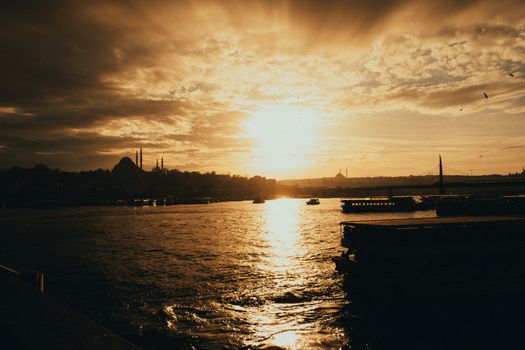 Stunning view of a sunset over Istanbul, showcasing city silhouette and Bosphorus reflection.