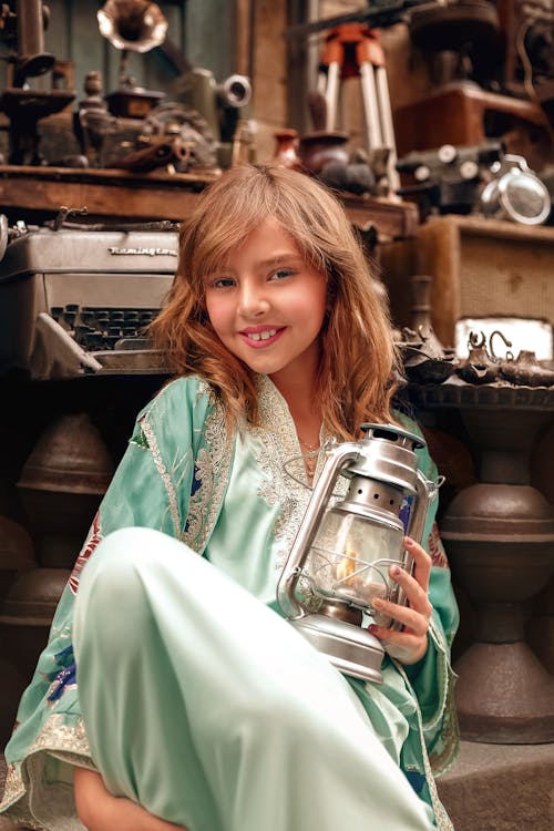 Child Model in Long Blue Dress Holding Vintage Lantern