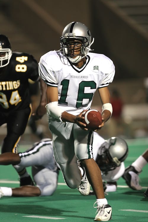 Man in White 16 Football Jersey While Playing Football