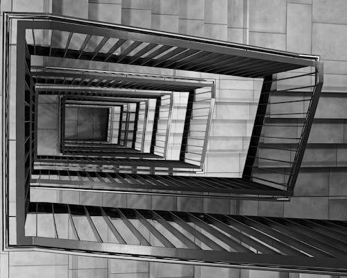 Black and White Photo of a Spiral Staircase 