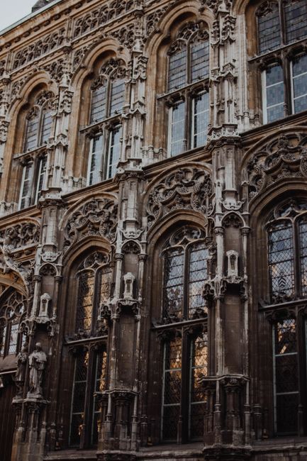 Detailed Gothic facade in Brussels showcasing intricate stonework and history.